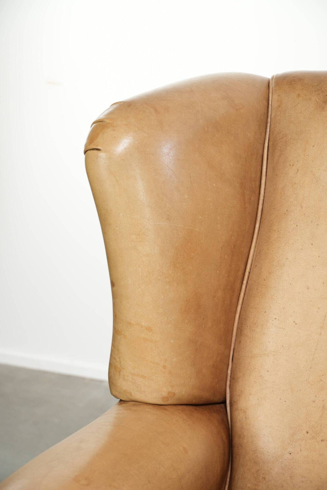 Set of two light cowhide wingback armchairs with a timeless English look