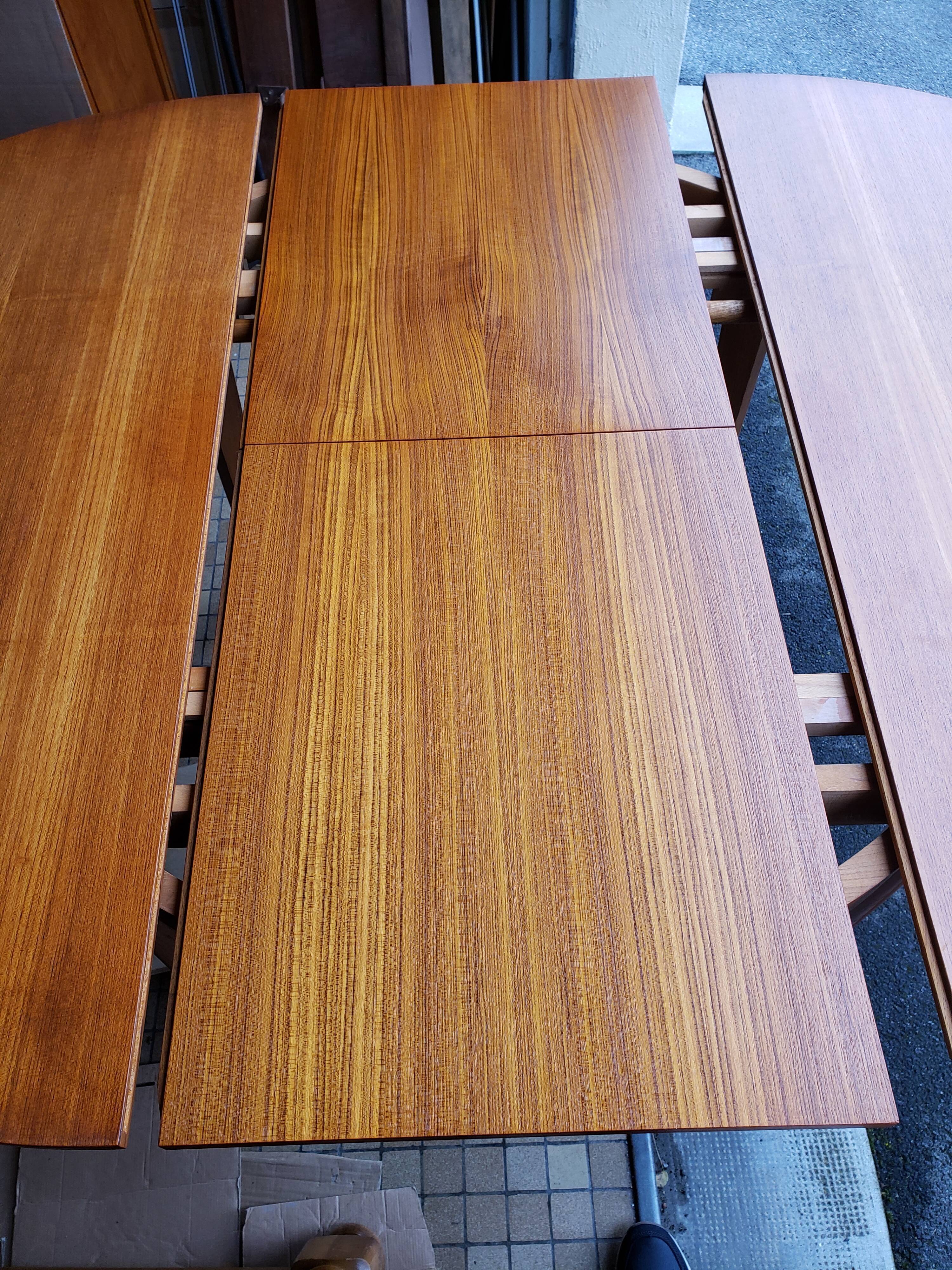 Round extendable teak dining table from the 60s