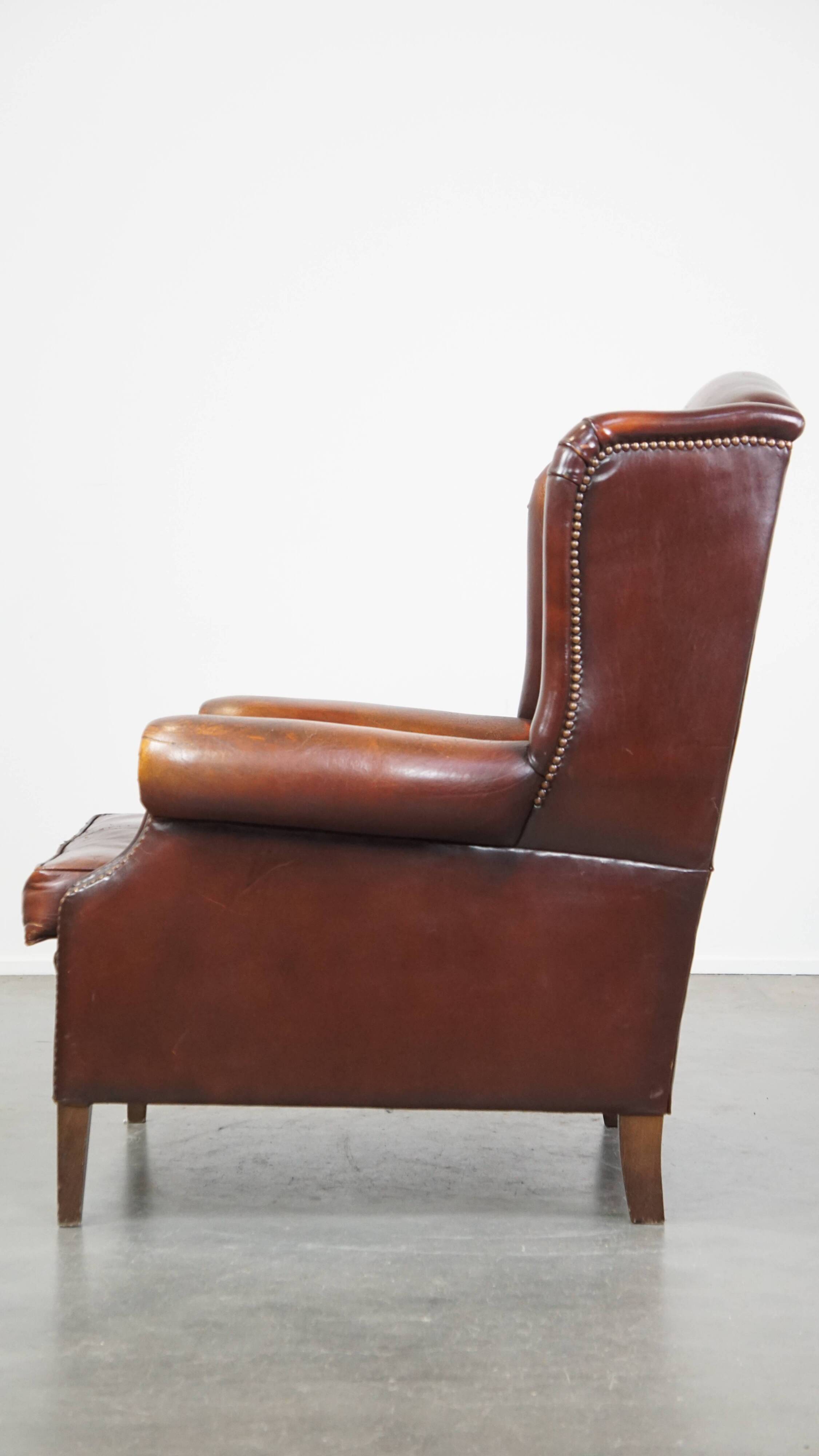 Dark English style sheepskin wingback chair with character and patina