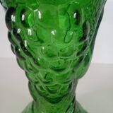 Green glass vase decorated with bunch of grapes and fruits