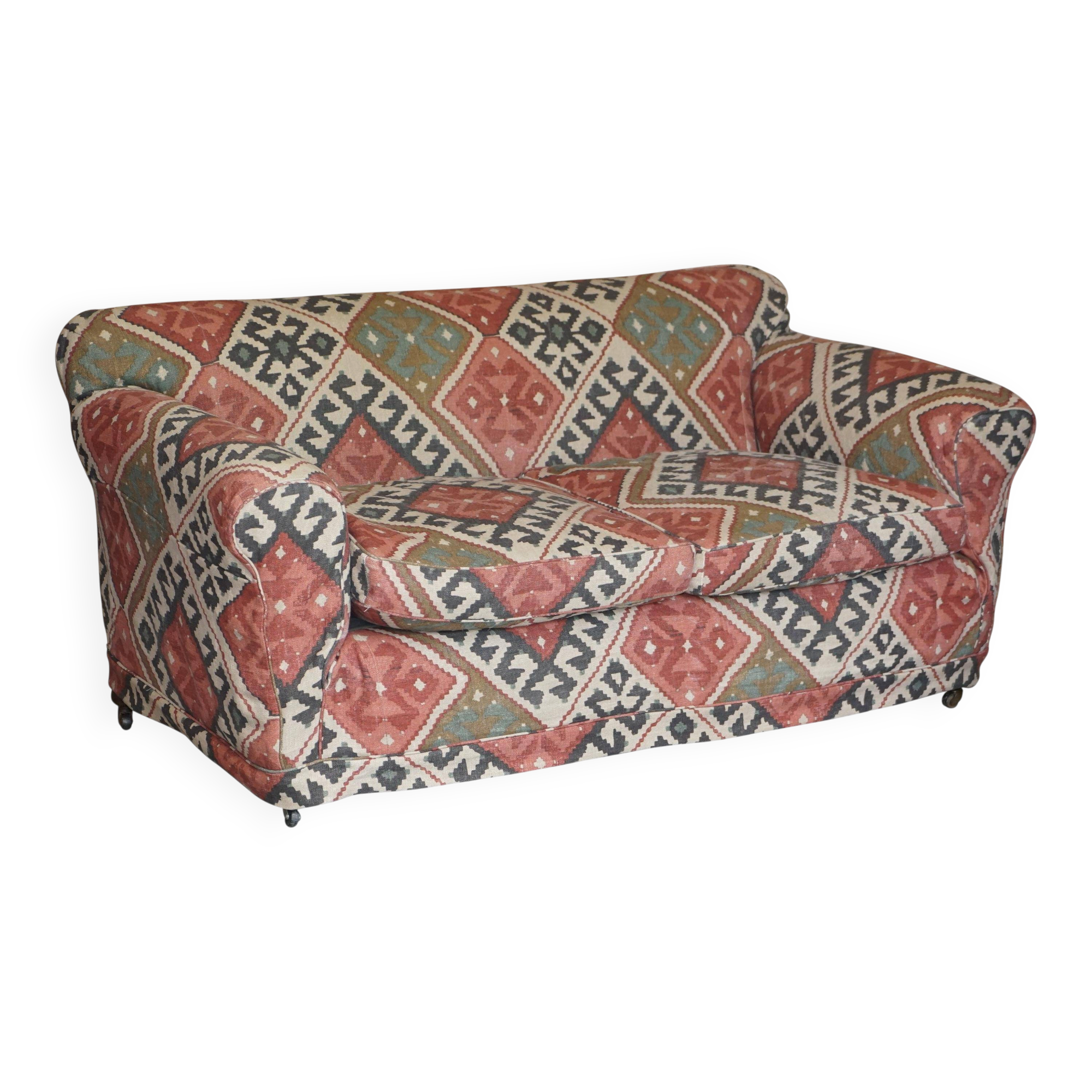 Victorian canapé upholstered in Kilim with turned mahogany legs.