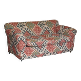 Victorian canapé upholstered in Kilim with turned mahogany legs.