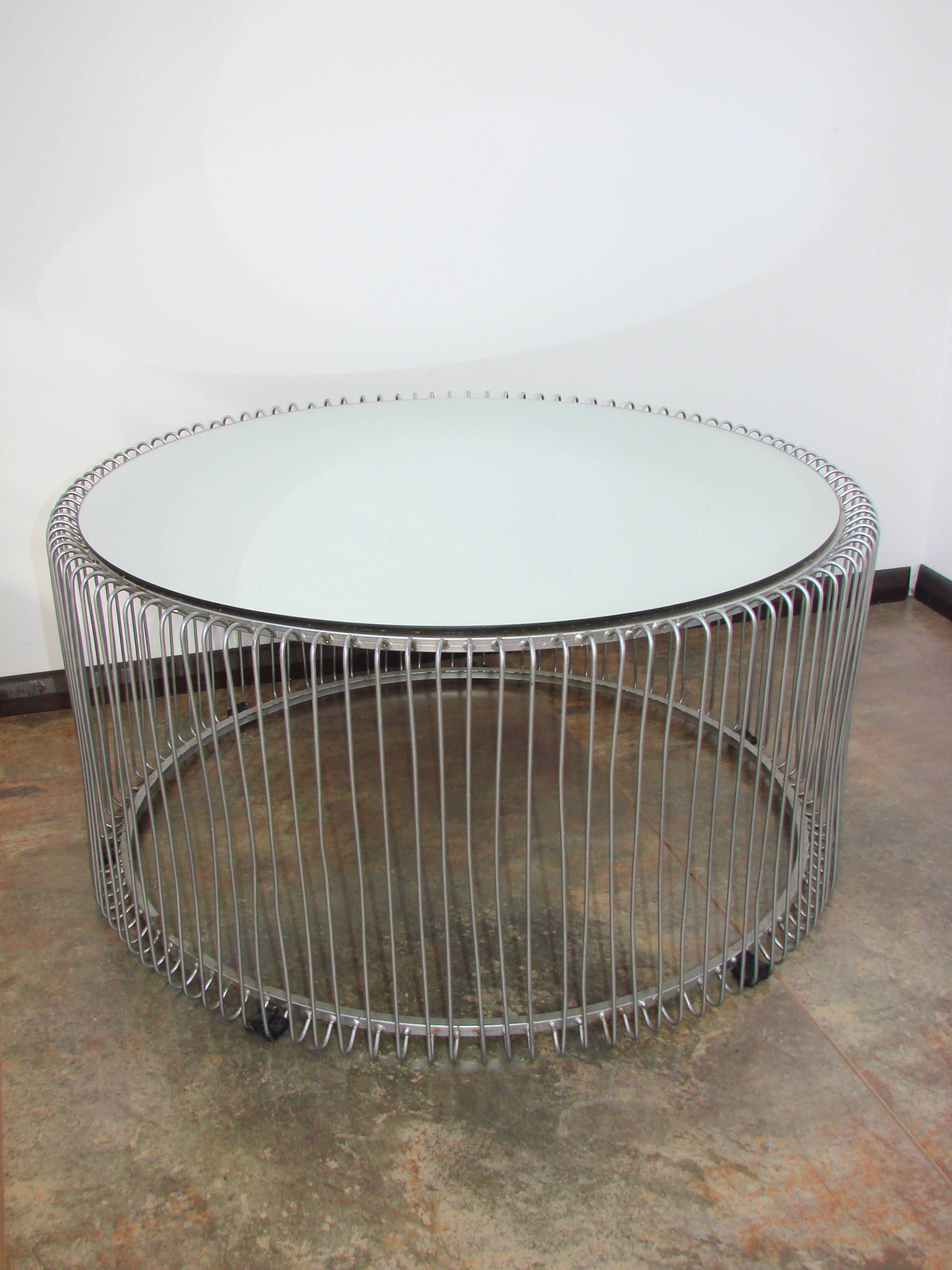 A round coffee table with a mirrored top, from the 1990s.