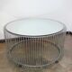 A round coffee table with a mirrored top, from the 1990s.