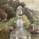 Antique stemmed blown glass bottle with engraved medallion