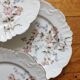 12 assiettes à dessert en porcelaine ancienne décor polychrome floral début XXe