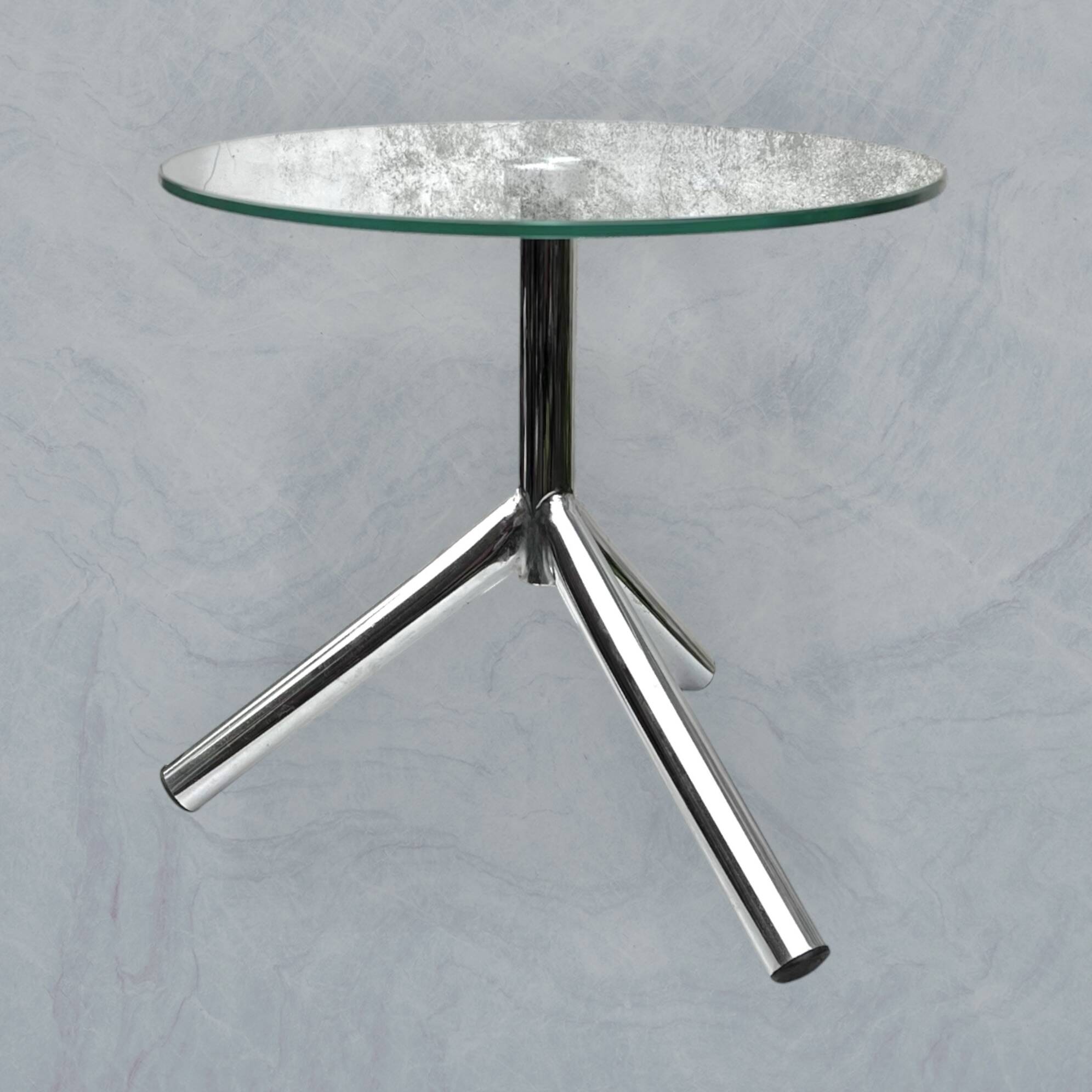 Modernist tripod side table in tempered glass and chrome metal.