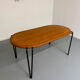 Solid wood dining table with tubular legs, 1980s postmodern design.