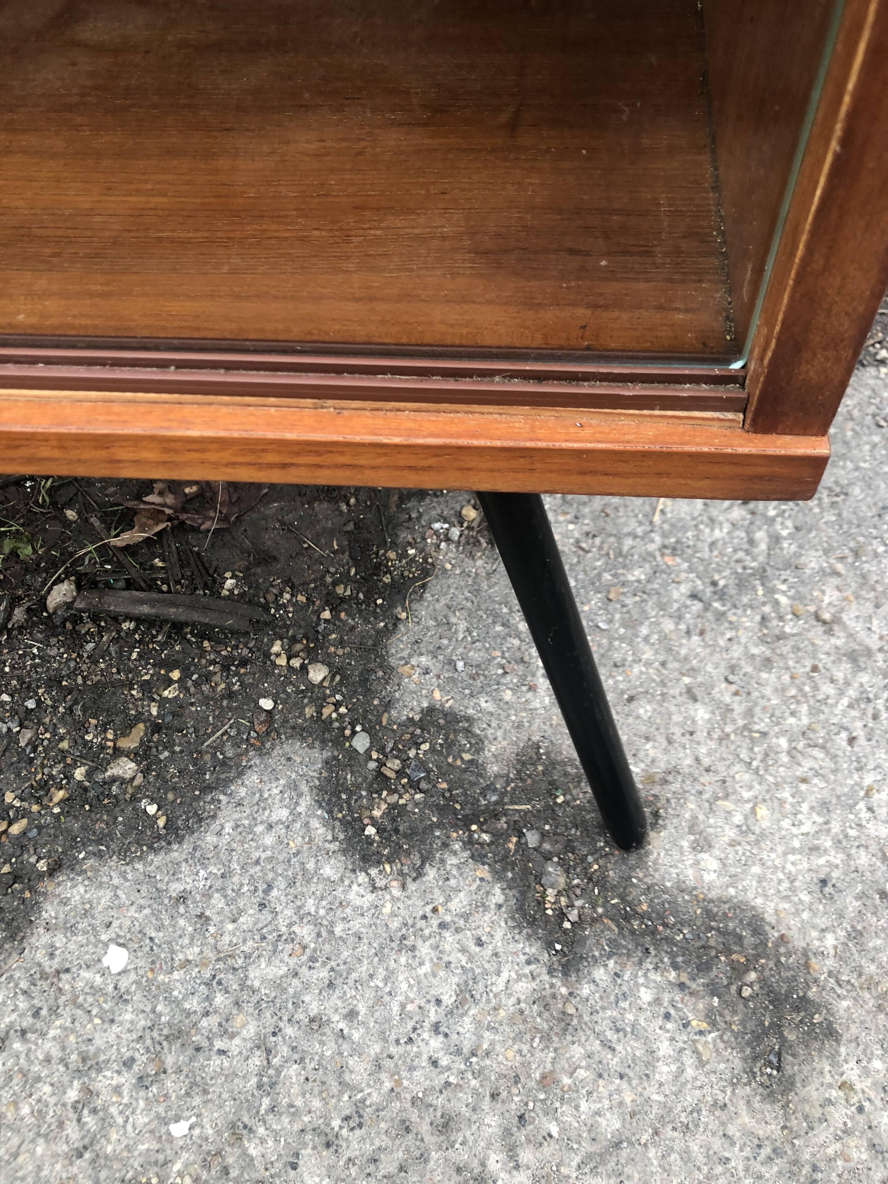 Library showcase with sliding glass doors 60s