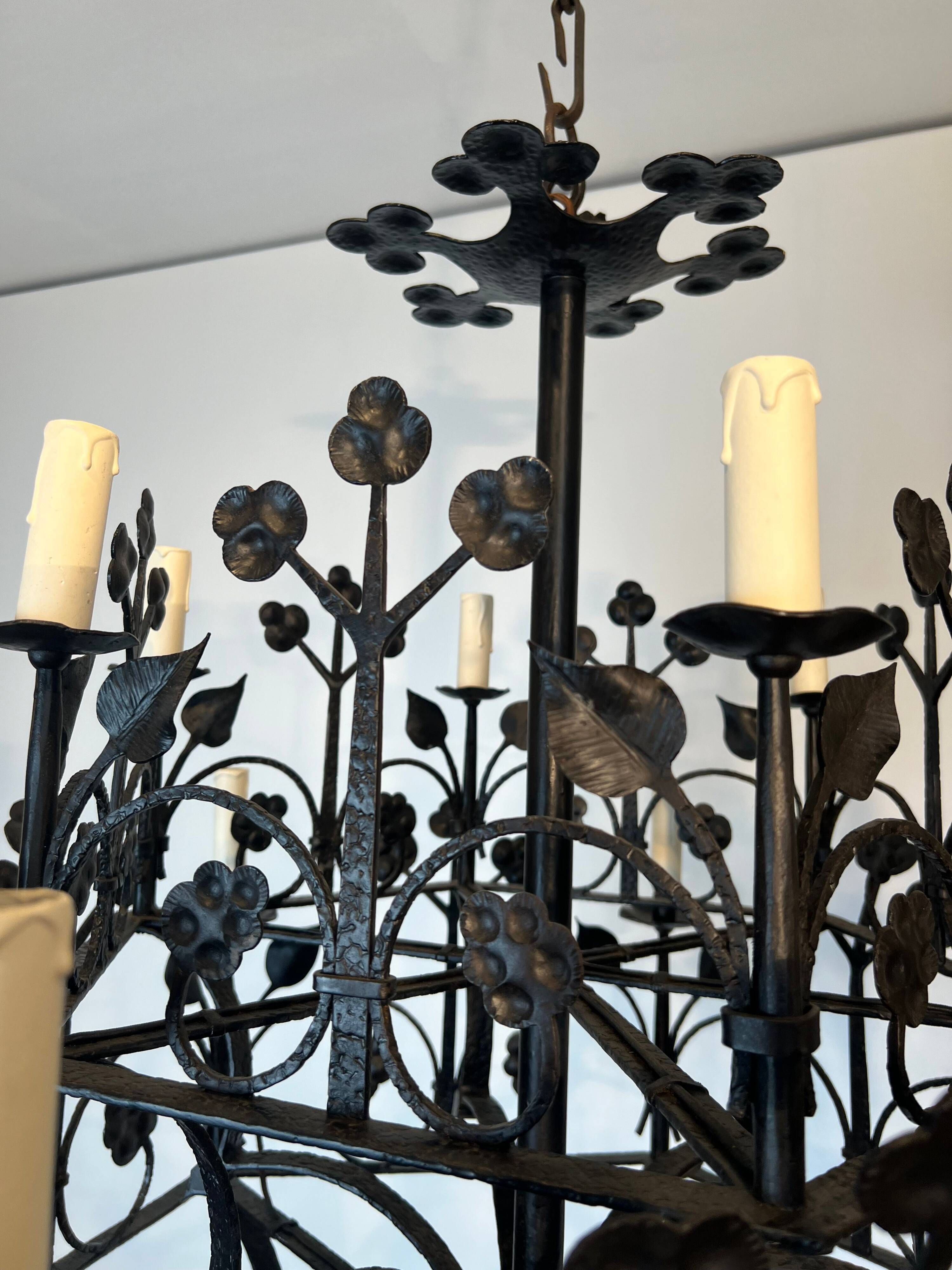 Lustre with 12 lights in wrought iron decorated with clovers and foliage.