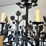 Lustre with 12 lights in wrought iron decorated with clovers and foliage.