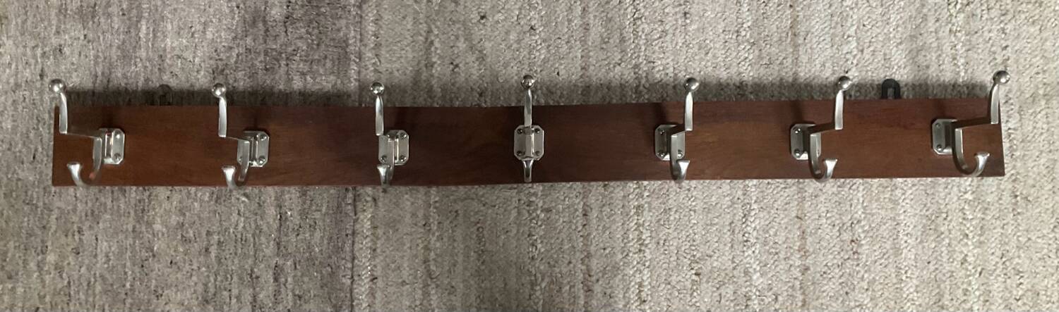 Wall coat rack from the 1950s-60s in solid oak and stainless steel.