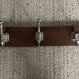 Wall coat rack from the 1950s-60s in solid oak and stainless steel.