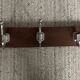 Wall coat rack from the 1950s-60s in solid oak and stainless steel.