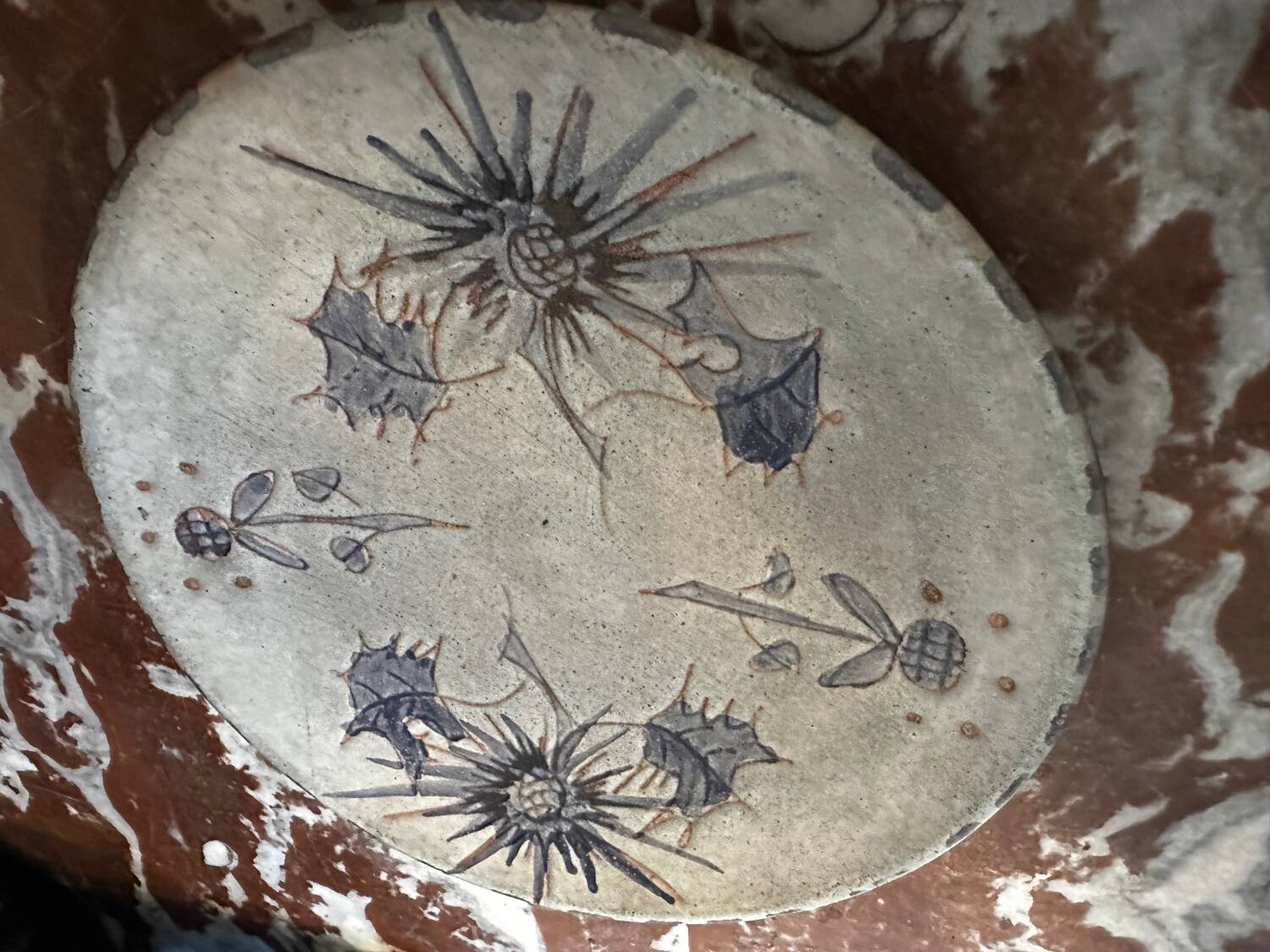 Ceramic plate signed by Marie-Madeleine Jolly – thistle decoration – year