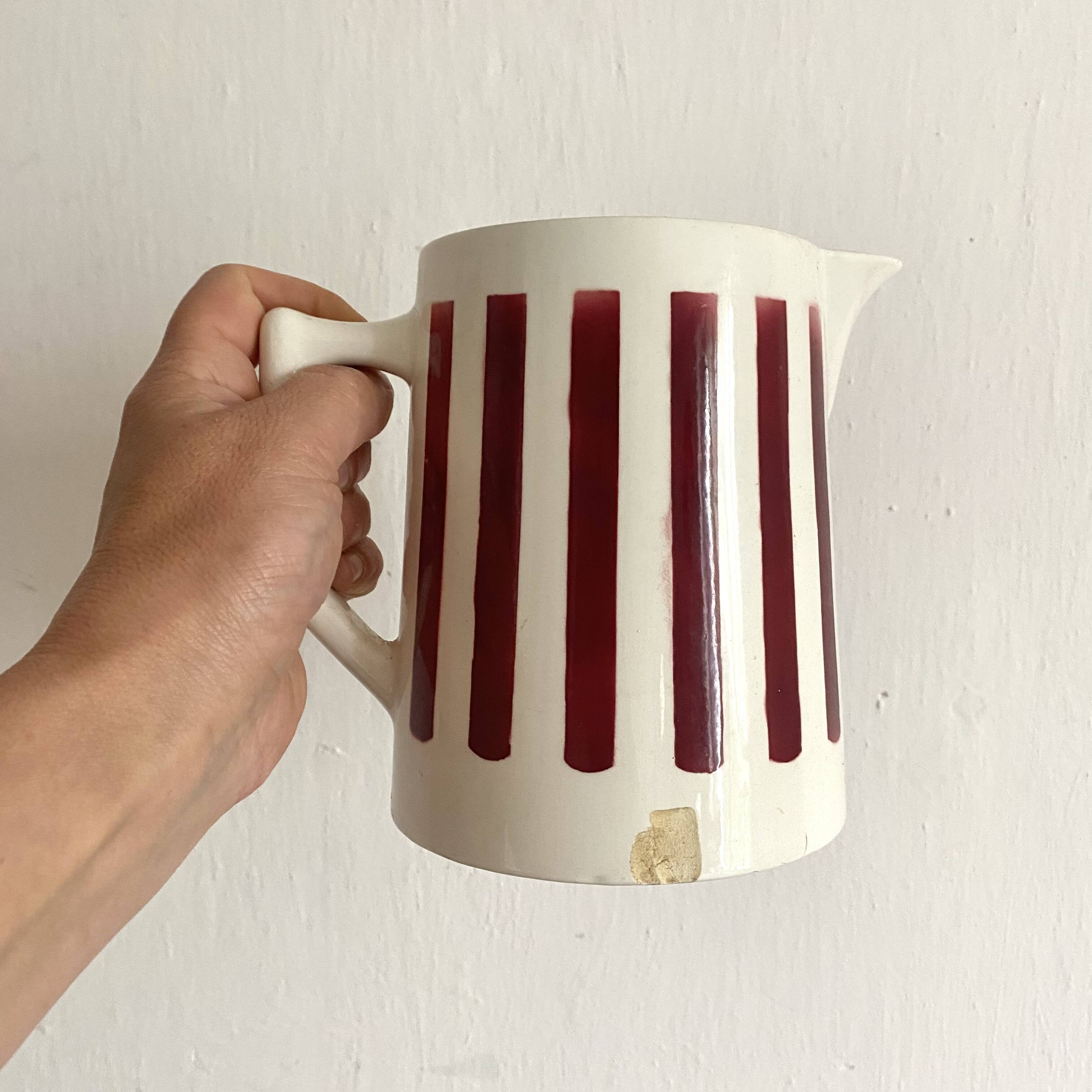 Antique earthenware pitcher with burgundy stripes