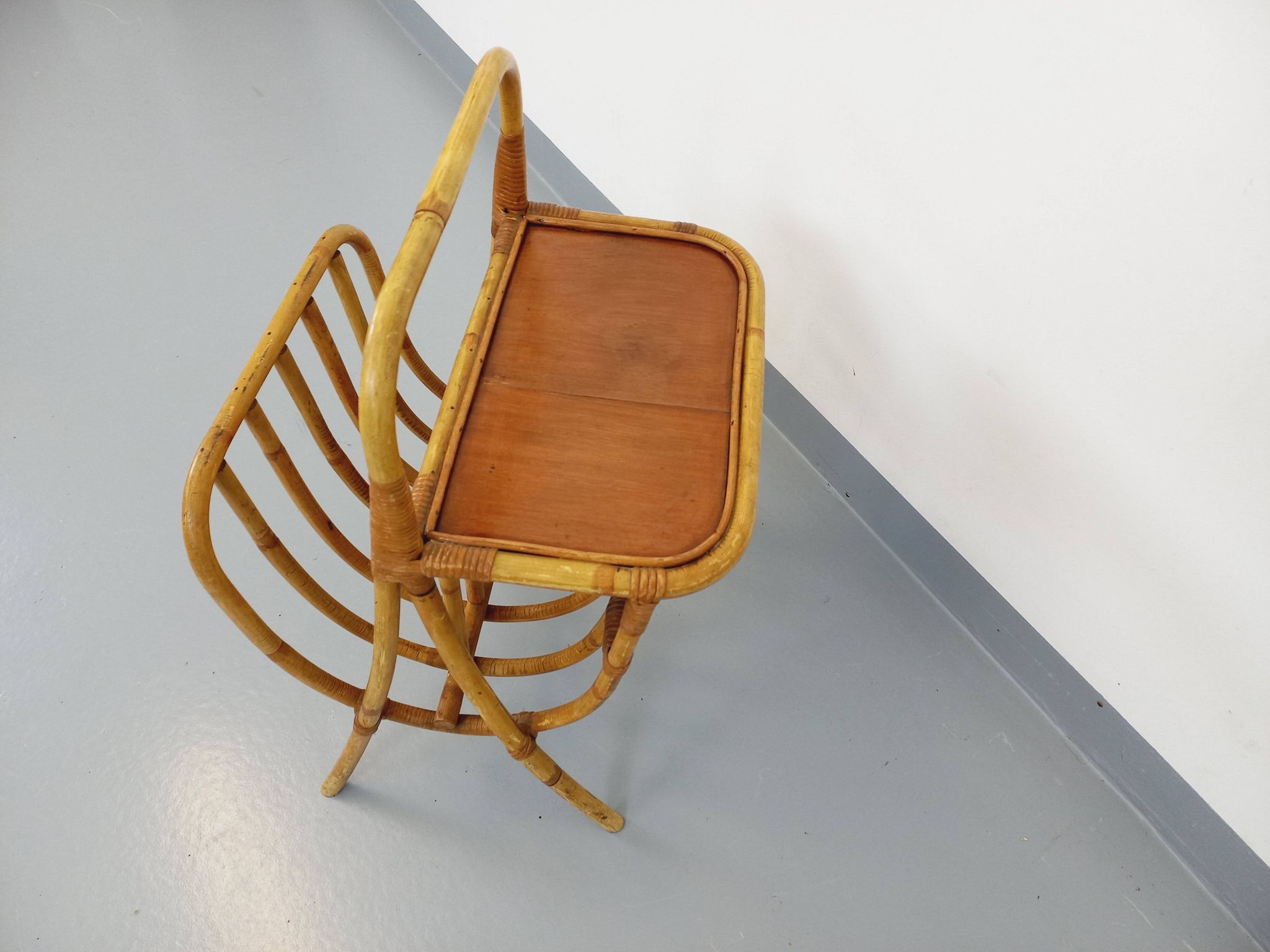 Side table with vintage rattan and wood magazine rack from the 60s