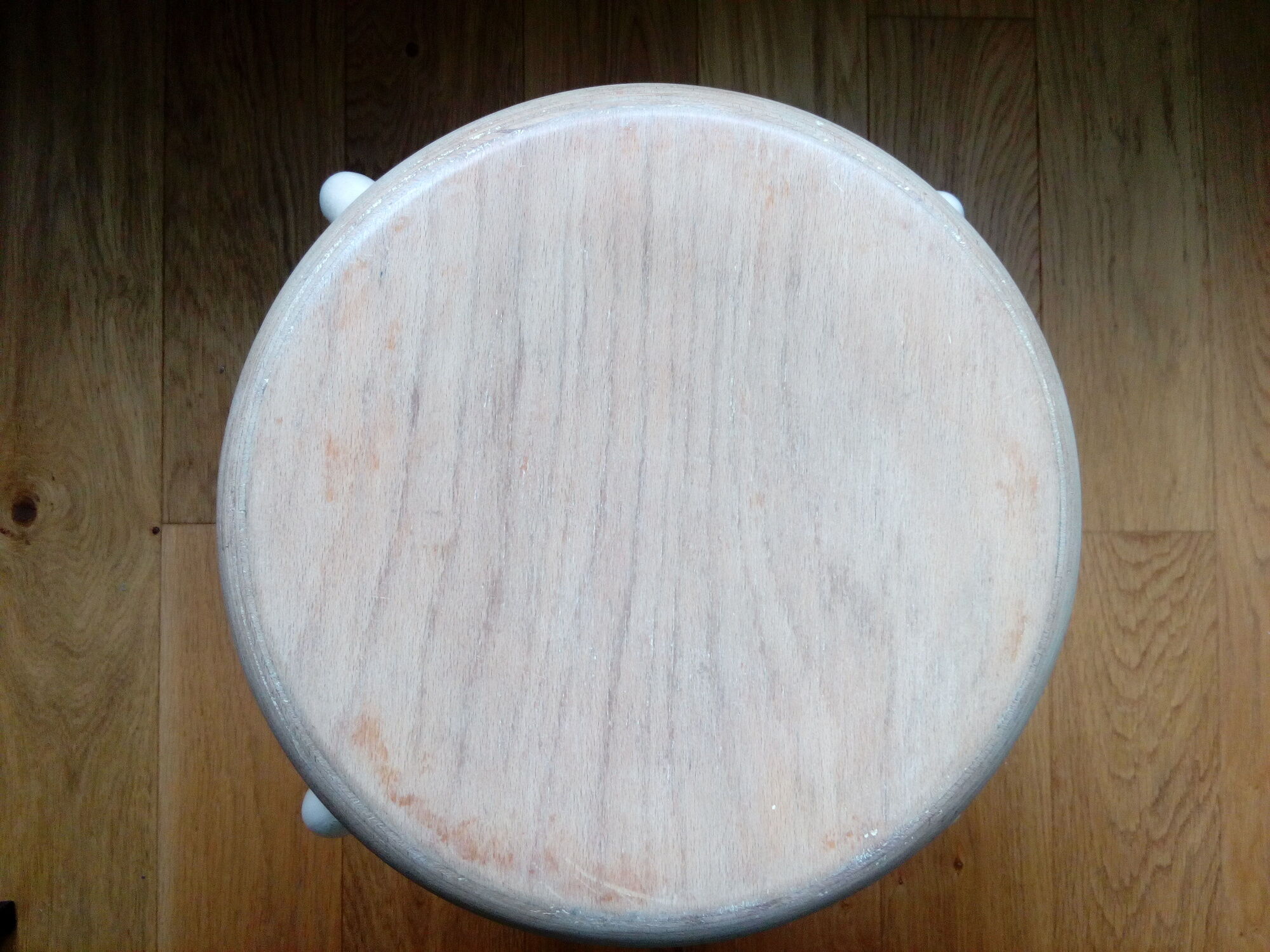 Industrial tubular metal stick sitting round in wood