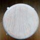 Industrial tubular metal stick sitting round in wood