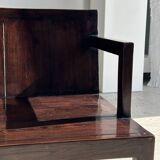 Small low armchair in varnished brown wood