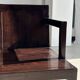 Small low armchair in varnished brown wood