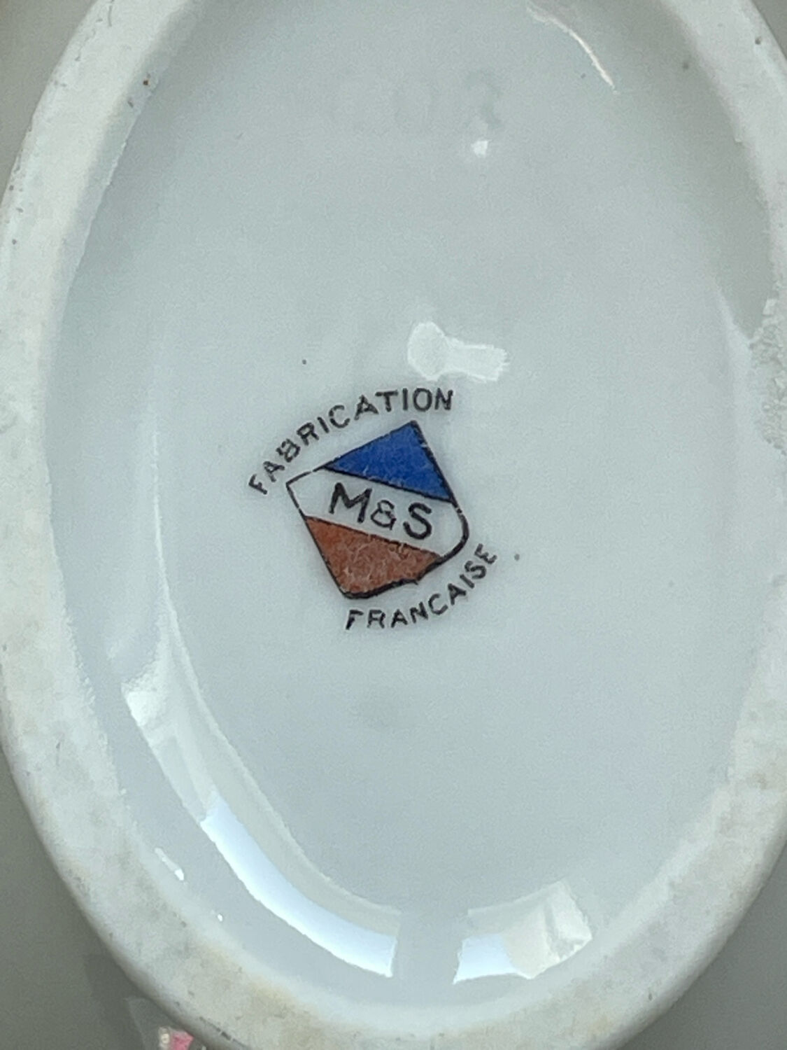 Antique white French porcelain sauce boat M&S with silver trim.