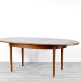 A stylish vintage teak danish influenced extending dining table for sale.  Supported on four slender