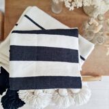 Hand-woven plaid with black stripes and white pompoms