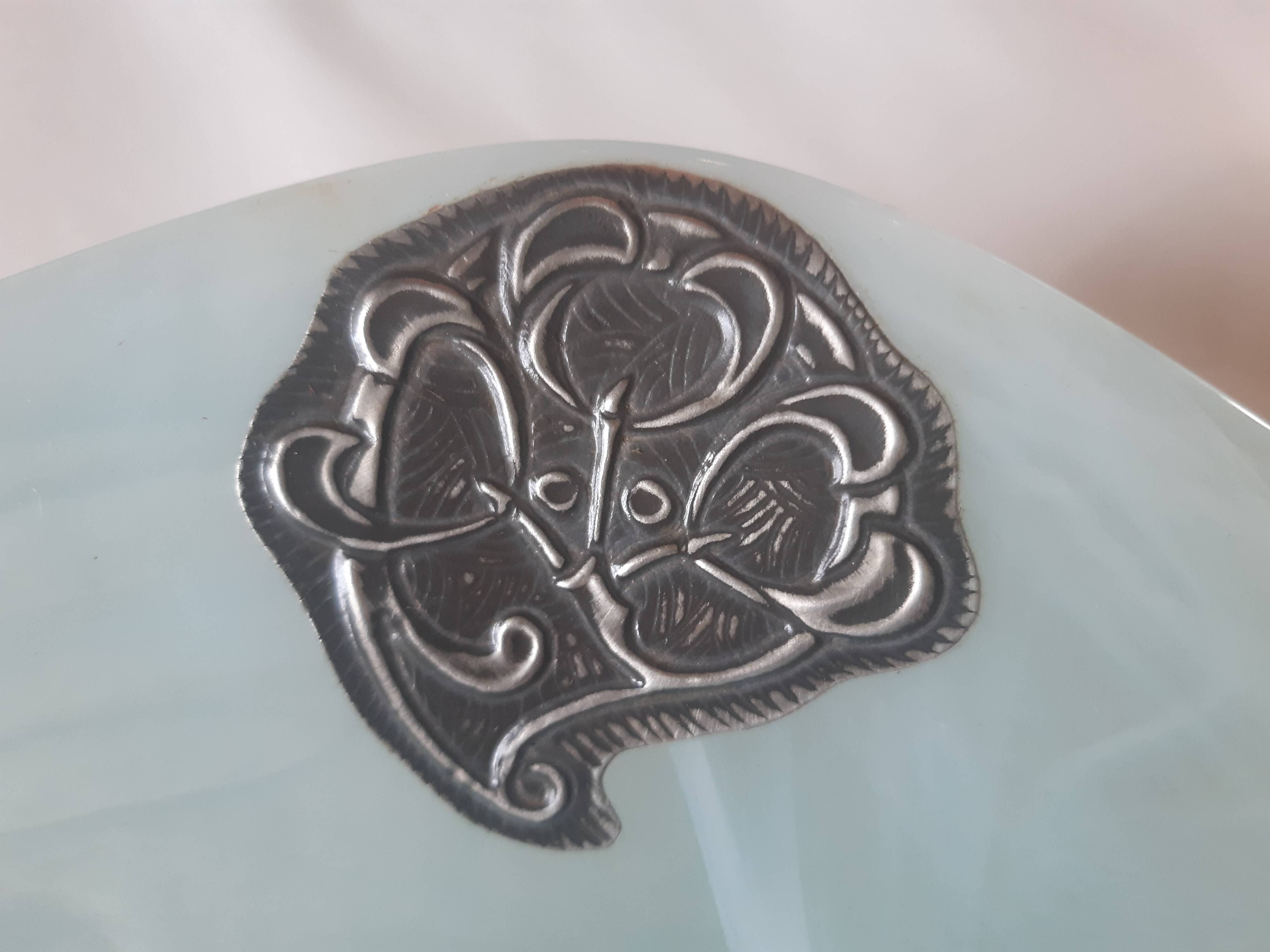 Handcrafted glass fruit bowl with ribbed design set with pewter medallions.