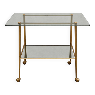 Vintage 1970s glass and gold rolling console table.
