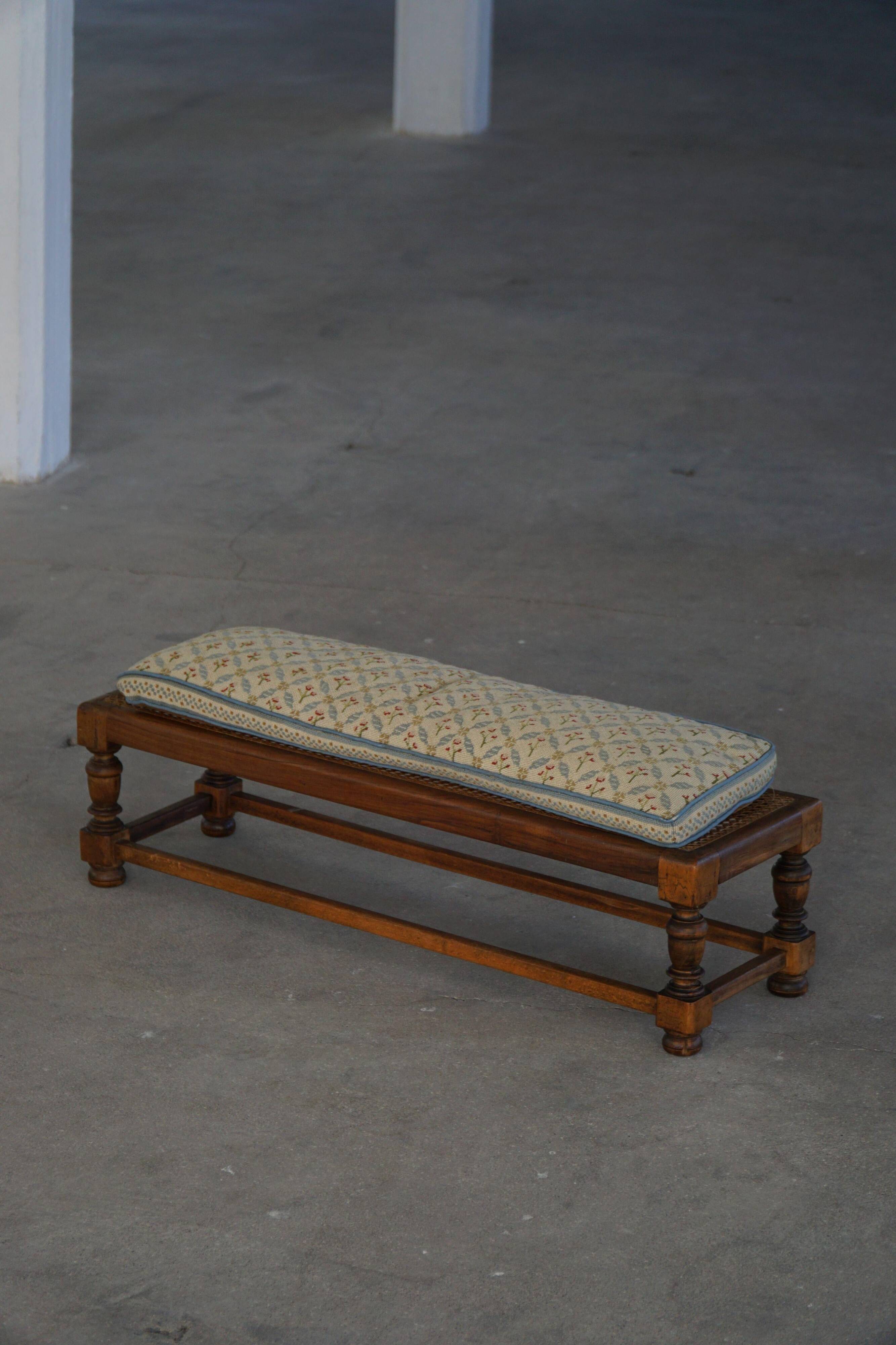 Danish oak footrest with hand-embroidered cushion and rattan seat, baroque, 1940s.
