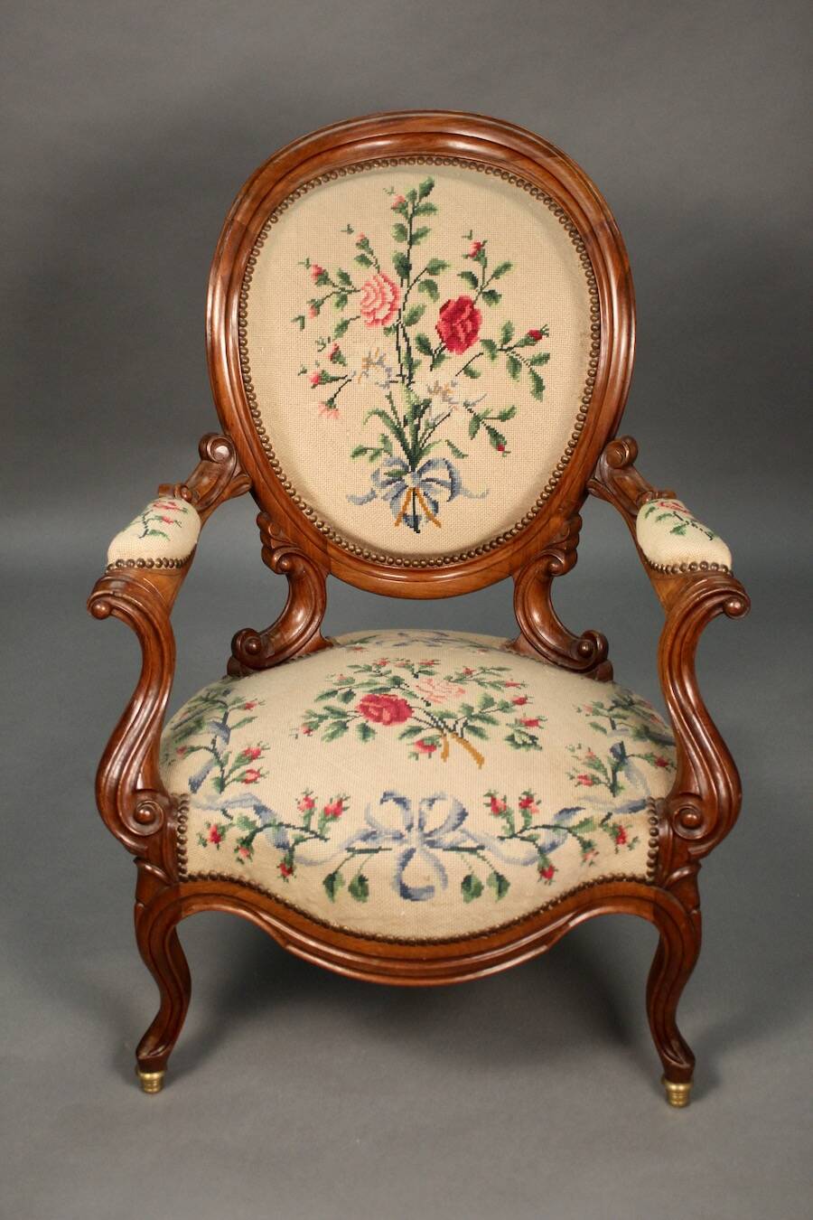 Pair of Louis Philippe armchairs with petit point upholstery.