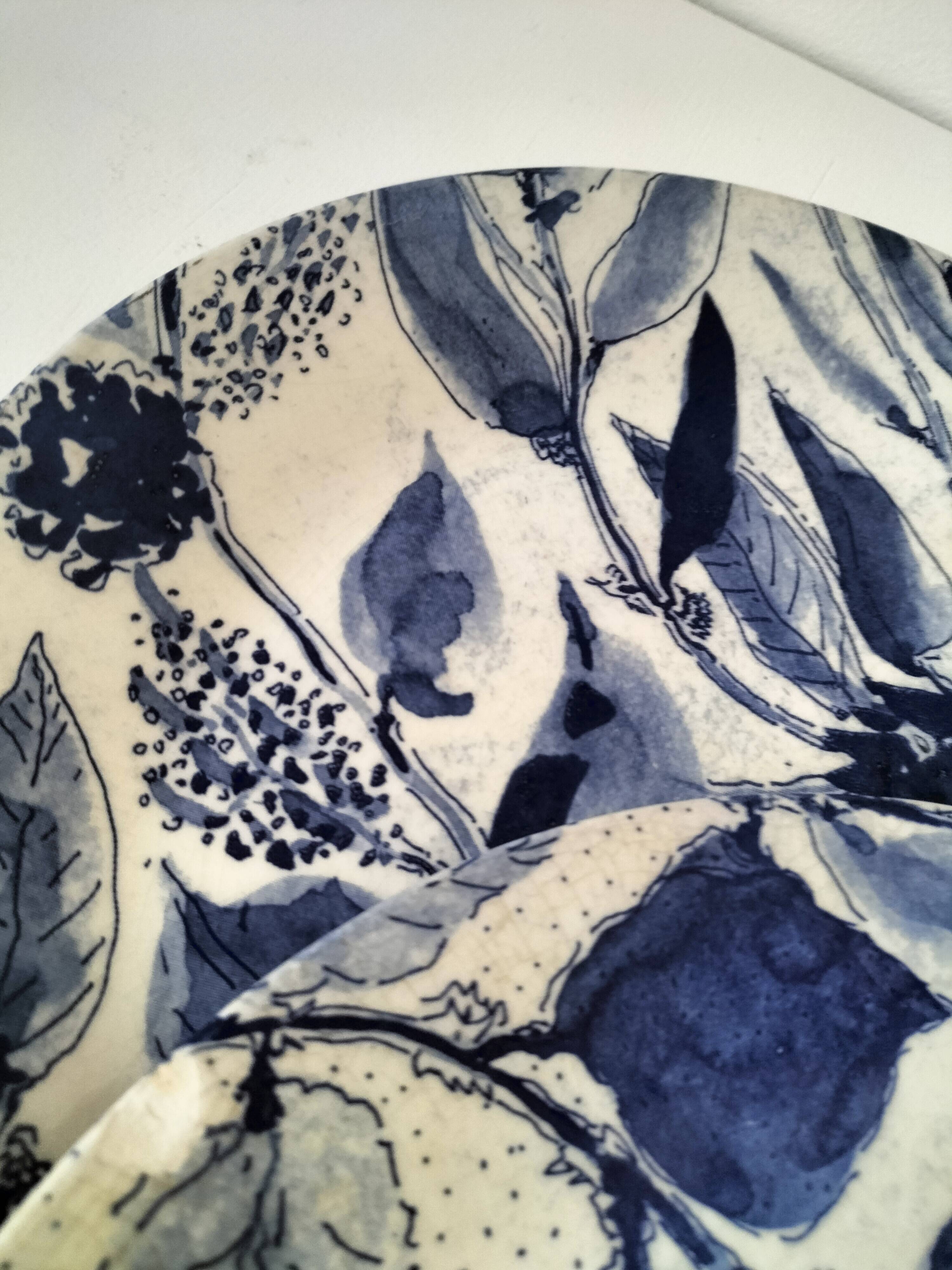 Two flat plates in earthenware with blue floral decoration.