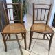 Pair of antique caned and wooden chairs from the 1900s.