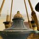 Empire style chandelier with four lights in sheet metal, bronze with patina and gilding