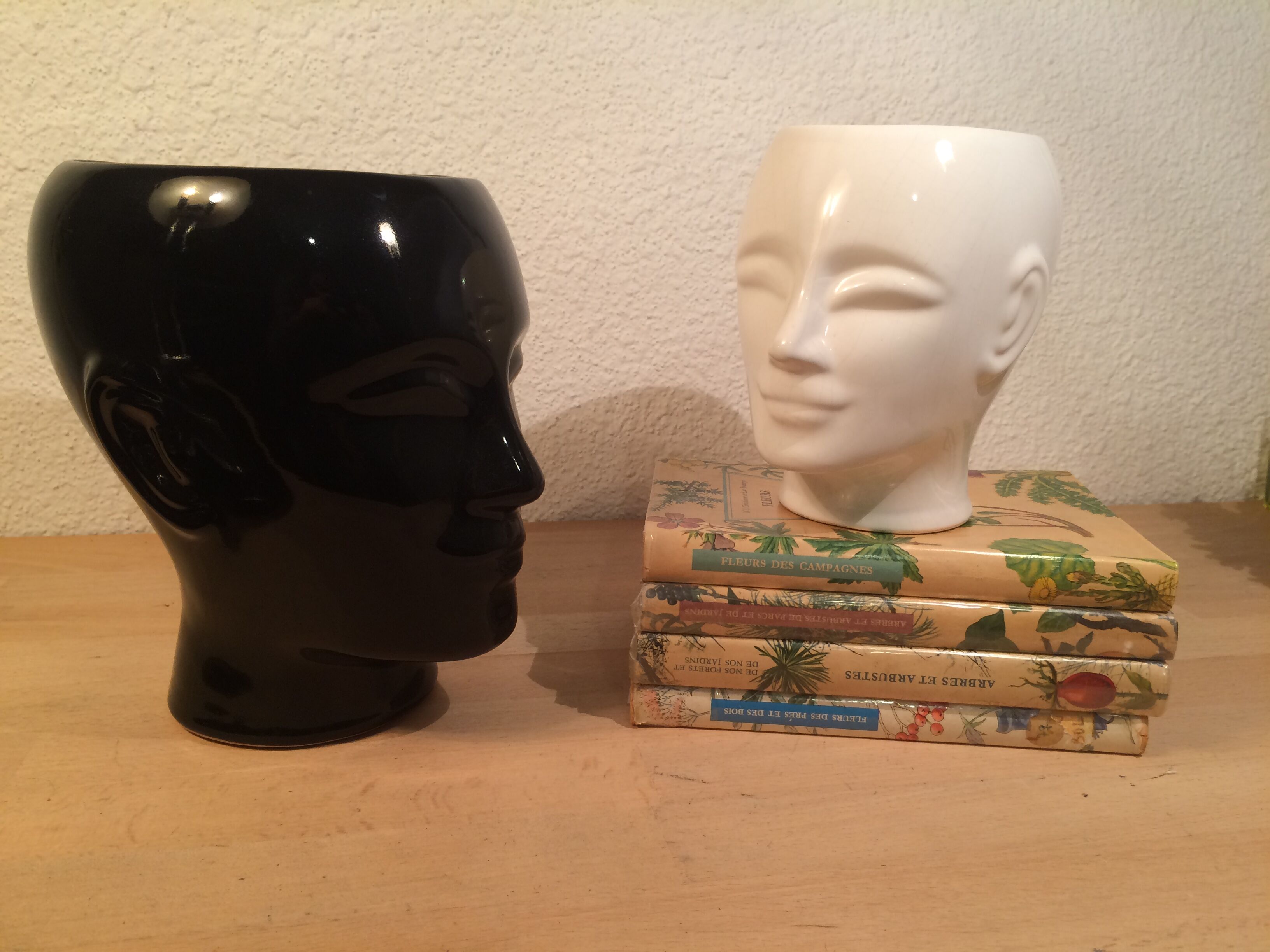 2 black and white ceramic head vases, face