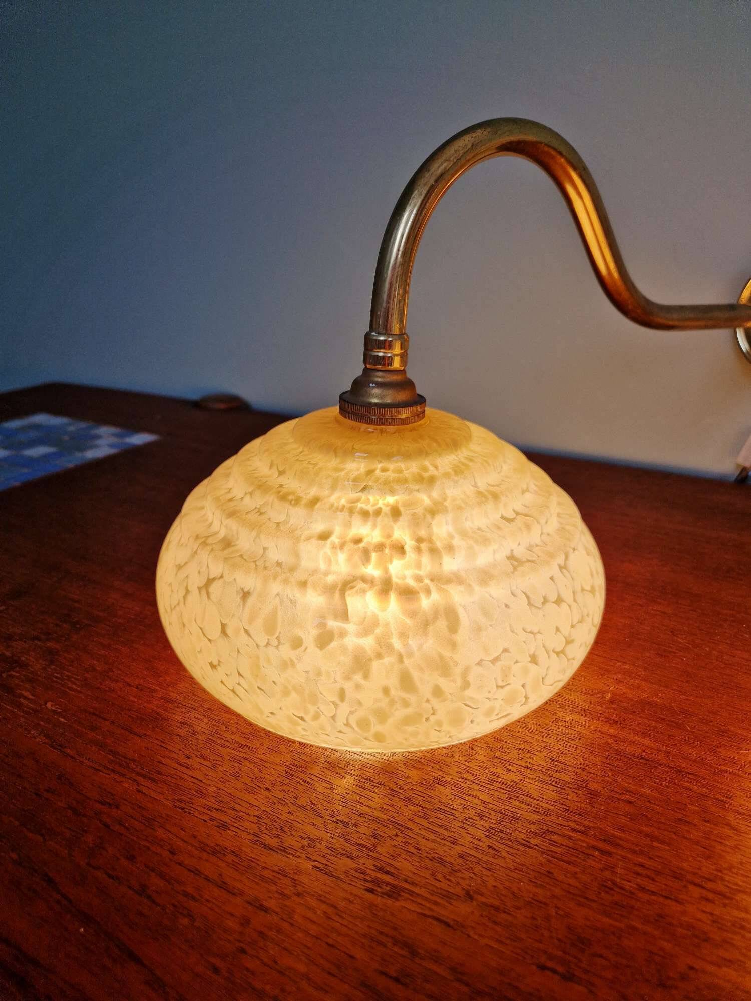 Pair of brass and yellow/white speckled glass wall sconces