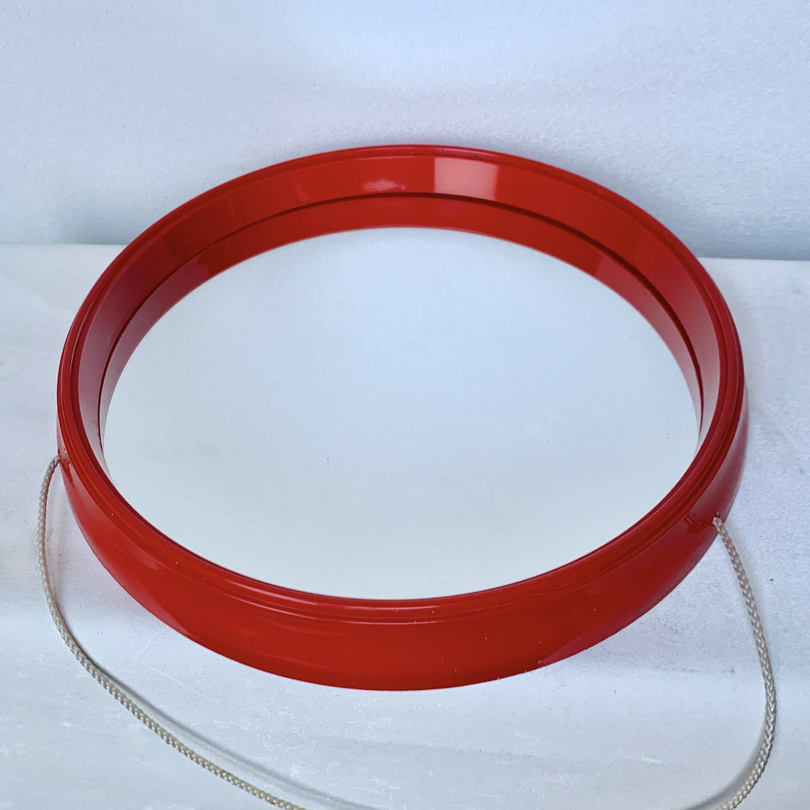Pair of vintage round red plastic mirrors