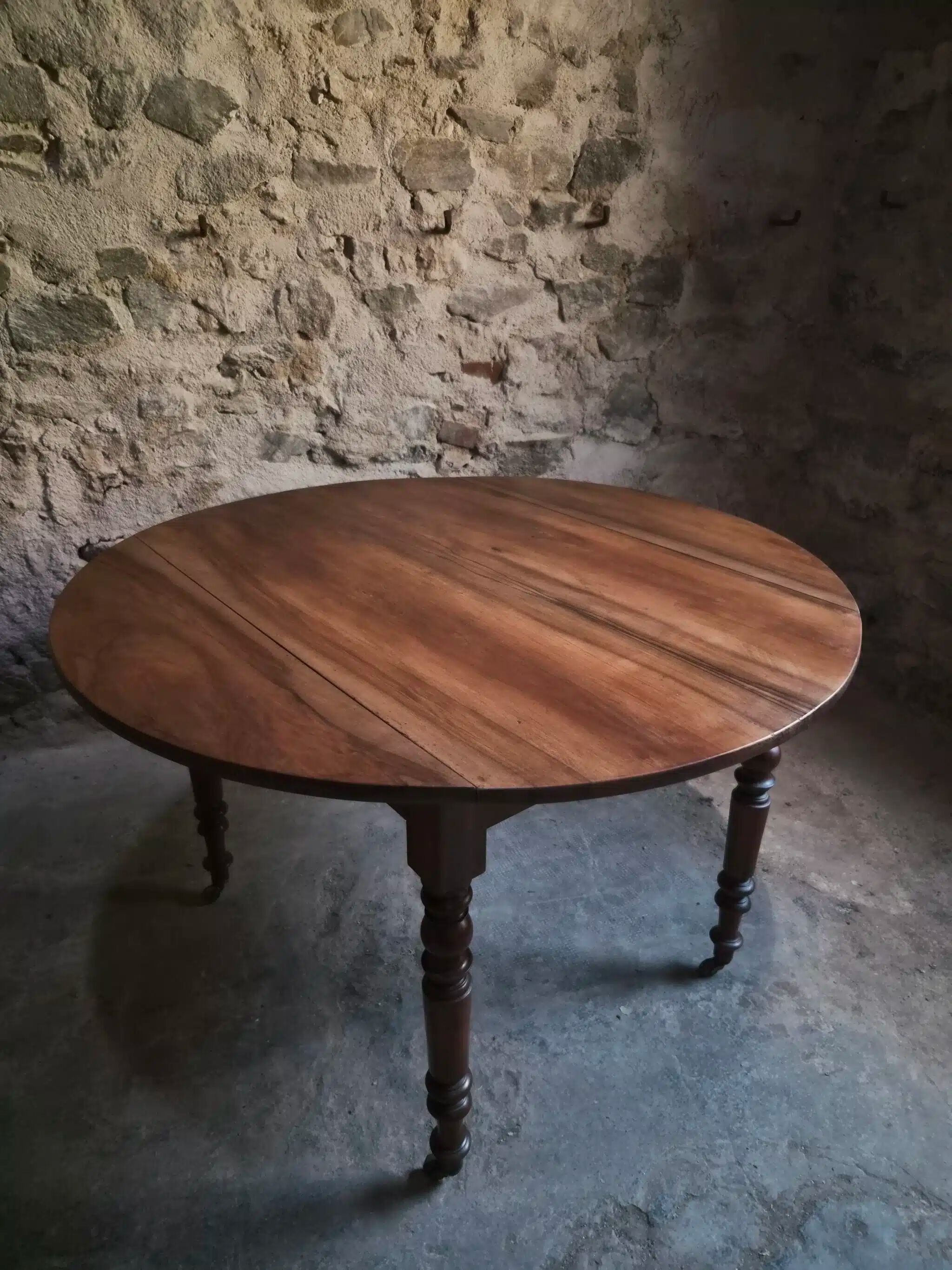 Antique drop-leaf dining table in walnut, France, circa 1900.