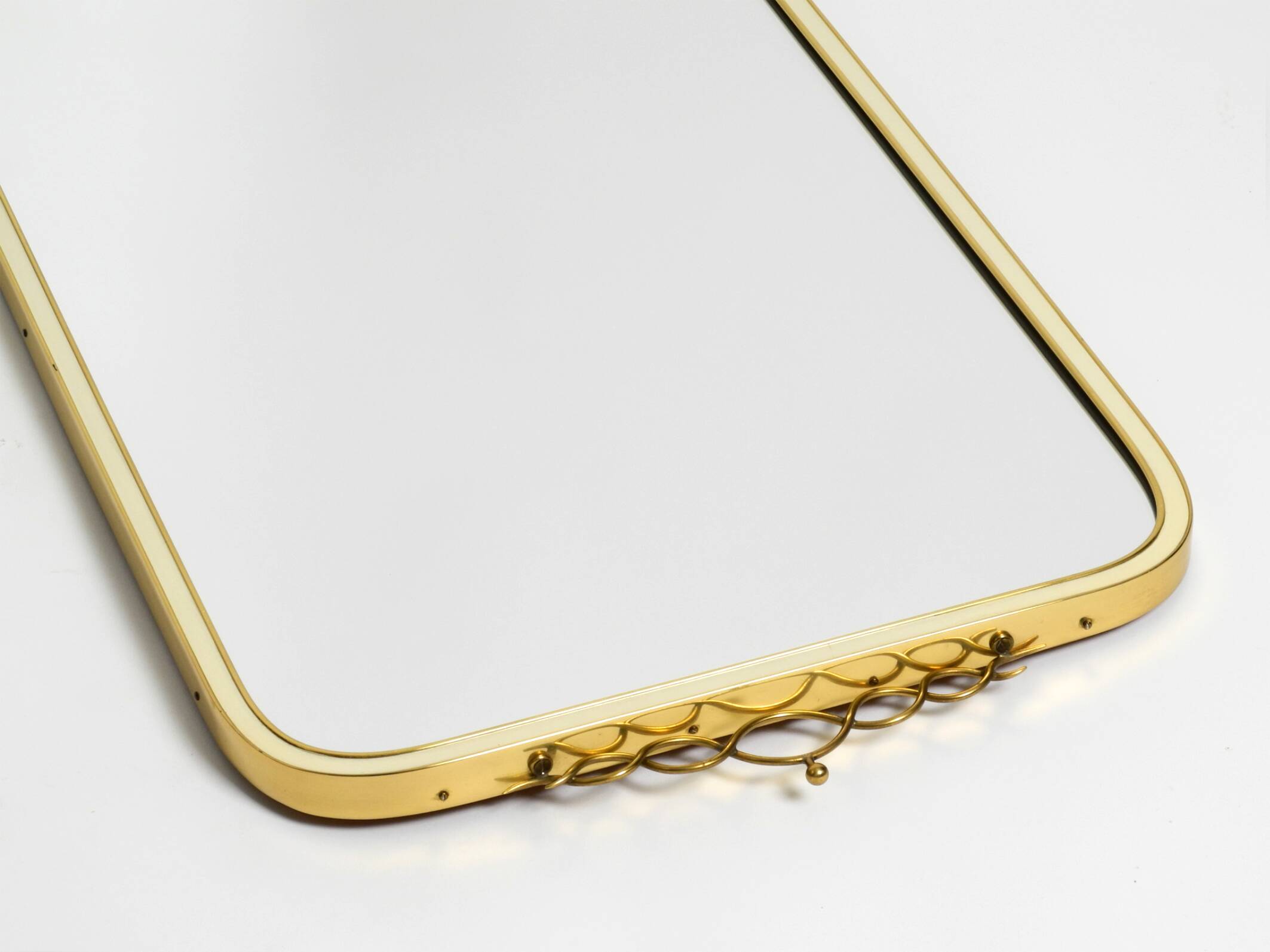Large heavy long Mid Century brass wall mirror by Münchner Zierspiegel
