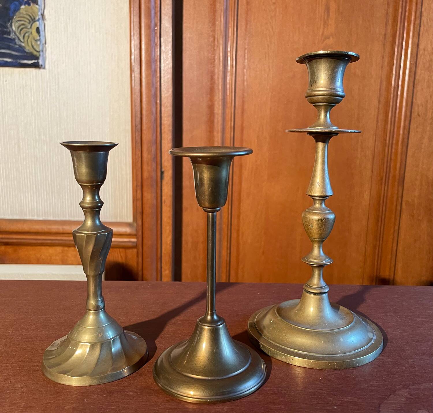 Trio of brass candlesticks