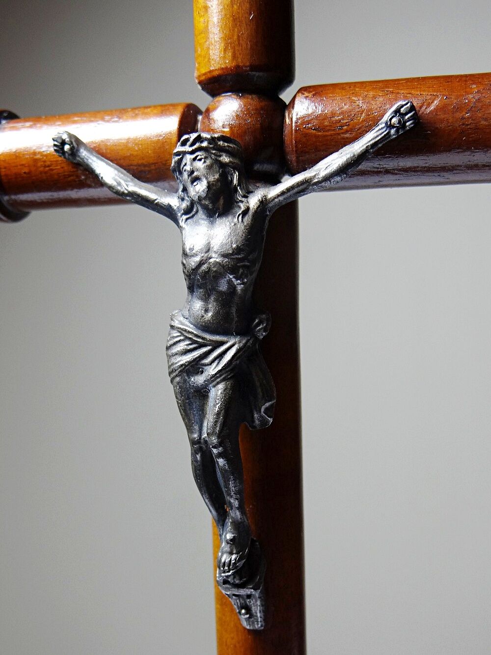 Antique wooden altar crucifix with a turned design and silver-plated Christ.