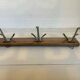 Old coat rack wood metal three hooks