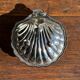 Vintage silver-plated shell butter dish with blue bowl.