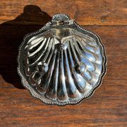 Vintage silver-plated shell butter dish with blue bowl.