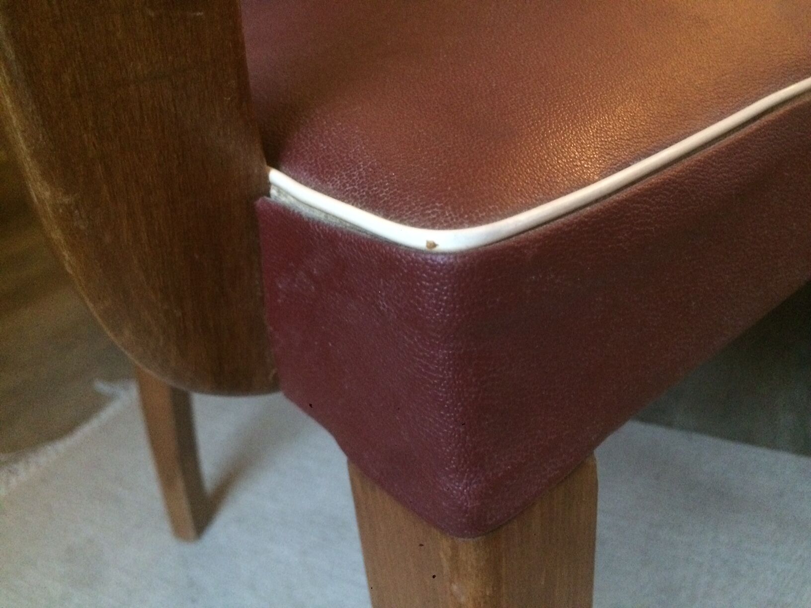Skai chair binds wine and wooden footpieces and armrests