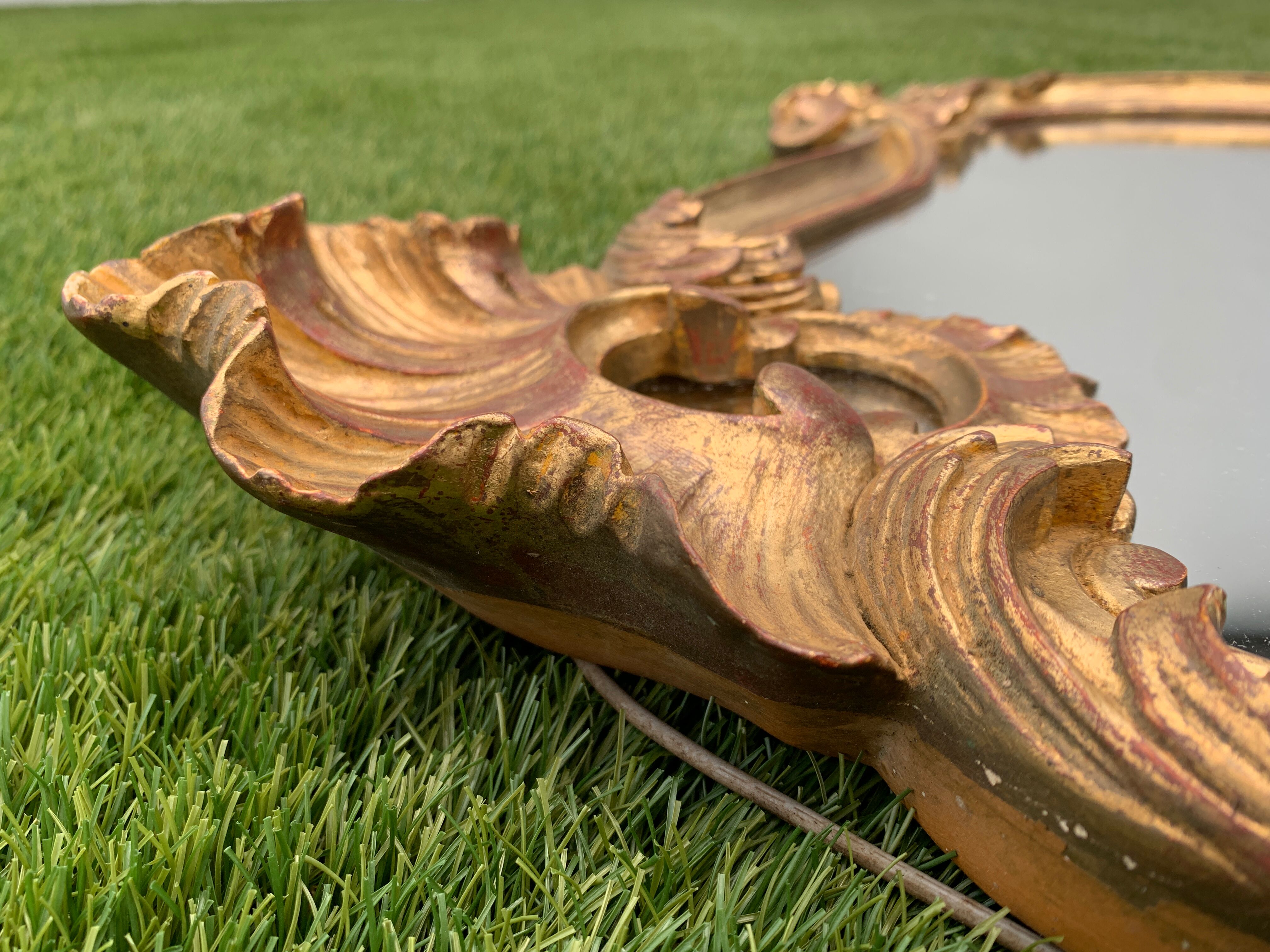 Old mirror in carved wood and gilded leaf, Louis XV rocaille style, twentieth century 59x87cm