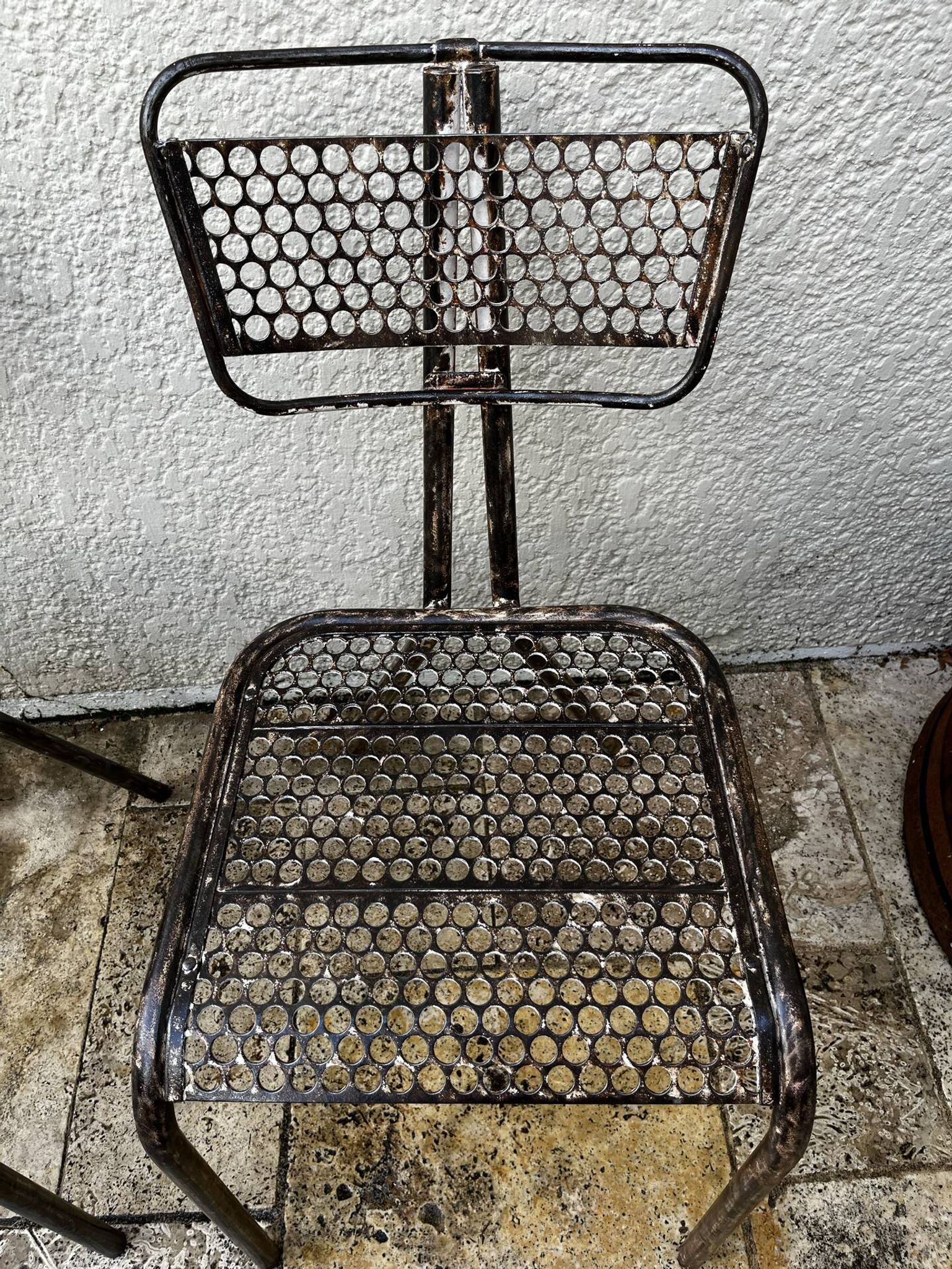 Pairs of perforated metal chairs by René Malaval