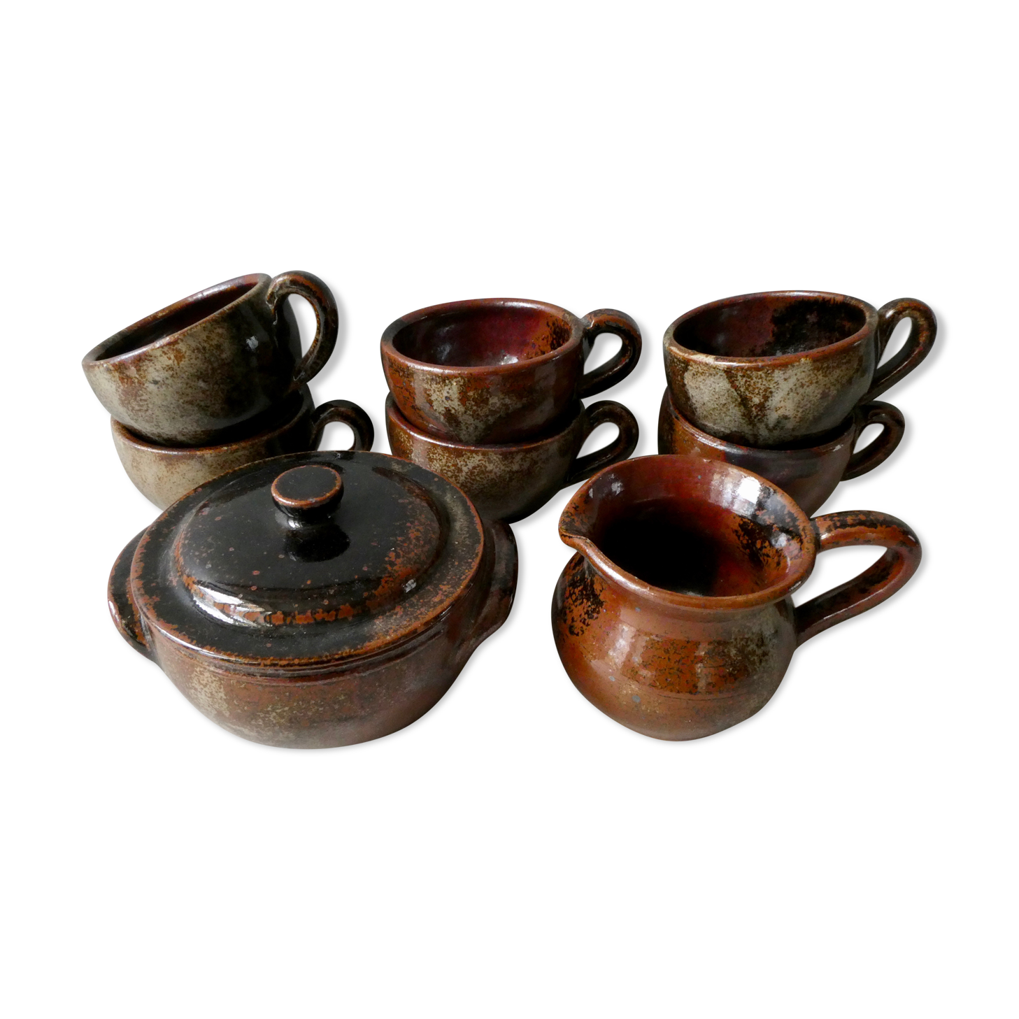 6 cups, 1 sugar bowl and 1 milk pot, made of sandstone by Isabelle Roger and Pierre Bernier