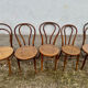 Set of 10 bentwood bistro chairs with cane seat.